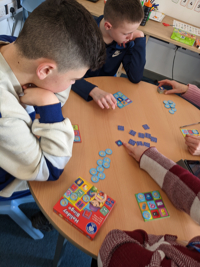 Pupils playing games around a table