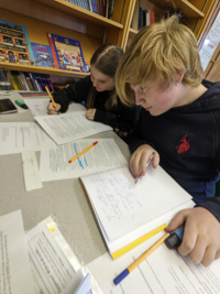Pupils studying their work books